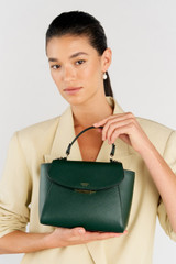 Profile view of model wearing the Oroton Inez Small Satchel in Juniper and Saffiano Leather for Women