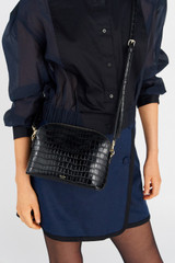 Profile view of model wearing the Oroton Inez Texture Slim Crossbody in Black Croc and Embossed Leather for Women
