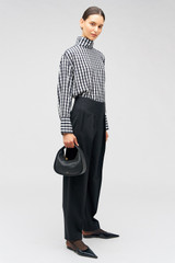 Profile view of model wearing the Oroton Waiter's Pant in Black and 53% polyester, 42% wool, 5% elastane for Women