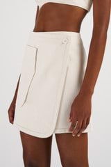 Profile view of model wearing the Oroton Denim Mini Skirt in Cream and 100% Cotton for Women