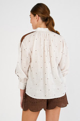 Profile view of model wearing the Oroton Embroidered Tulip Top in White/Chocolate and 100% linen for Women