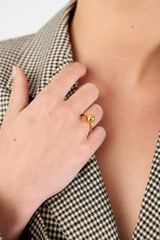 Profile view of model wearing the Oroton Sphere Ring in 18K Gold and Sustainably sourced 925 Sterling Silver for Women