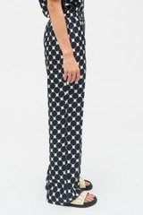 Profile view of model wearing the Oroton Penny Flower Pant in North Sea and 100% silk for Women