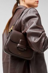 Profile view of model wearing the Oroton Carter Small Day Bag in Mahogany and Smooth leather for Women