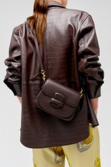 Profile view of model wearing the Oroton Carter Small Day Bag in Mahogany and Smooth leather for Women