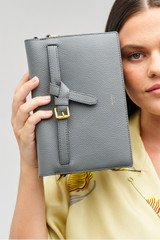 Profile view of model wearing the Oroton Margot Crossbody in Dark Slate and Pebble leather for Women