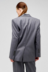 Profile view of model wearing the Oroton Man Style Blazer in Dark Ash and 50% wool, 50% recycled polyester for Women