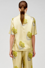 Profile view of model wearing the Oroton Linear Tulip Camp Shirt in Fennel and 100% silk for Women