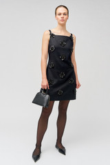 Profile view of model wearing the Oroton Flower Sequin Shift Dress in Black and 100% linen for Women