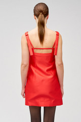 Profile view of model wearing the Oroton Satin Mini Dress in Poppy and 85% polyester, 15% silk for Women