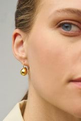Profile view of model wearing the Oroton Bonnie Tear Drop Bead Earrings in Gold and 100% Recycled Sterling Silver for Women