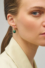 Profile view of model wearing the Oroton Bonnie Tear Drop Bead Earrings in Gold/Malachite and Sustainably sourced 925 Sterling Silver for Women