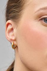 Profile view of model wearing the Oroton Bonnie Bead Charm Hoops in Gold and 100% Recycled Sterling Silver for Women