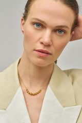 Profile view of model wearing the Oroton Bonnie Necklace in Gold and 100% Recycled Sterling Silver for Women