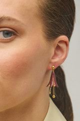 Profile view of model wearing the Oroton Lilium Drop Earrings in Gold/Currant and Brass for Women