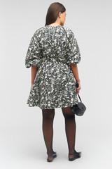Profile view of model wearing the Oroton Juniper Print Short Dress in Black and 100% silk for Women