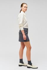 Profile view of model wearing the Oroton Poplin Long Sleeve Shirt in Cream and 100% cotton for Women