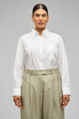 Profile view of model wearing the Oroton Poplin Long Sleeve Shirt in Cream and 100% cotton for Women