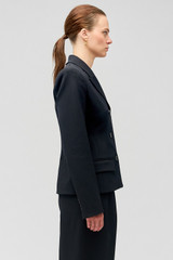 Profile view of model wearing the Oroton Shaped Double Breasted Blazer in Black and 53% polyester, 42% virgin wool, 5% elastane for Women