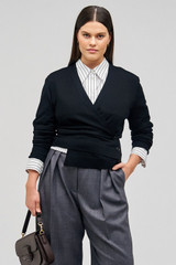 Profile view of model wearing the Oroton Wrap Cardigan in Black and 100% merino wool for Women