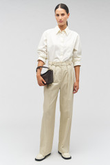 Profile view of model wearing the Oroton Tab Detail Pant in Limestone and 77% cotton, 23% linen for Women