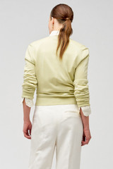 Profile view of model wearing the Oroton Wrap Cardigan in Fennel and 100% merino wool for Women