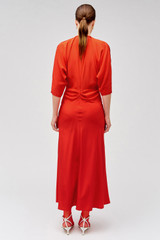 Profile view of model wearing the Oroton Split Neck Dress in True Red and 100% silk for Women