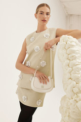 Profile view of model wearing the Oroton Flower Sequin Mini Skirt in Limestone and 100% linen for Women