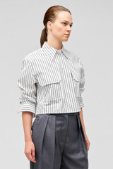Profile view of model wearing the Oroton Pinstripe Cropped Shirt in White and 100% cotton for Women