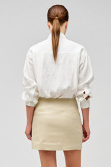 Profile view of model wearing the Oroton Flower Sequin Overshirt in Antique White and 100% linen for Women