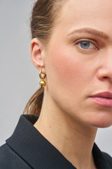 Profile view of model wearing the Oroton Bonnie Sphere Charm in Gold and 100% Recycled Sterling Silver for Women