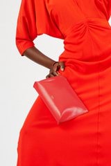 Profile view of model wearing the Oroton Mia Texture Pouch in True Red and Textured leather for Women
