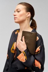 Profile view of model wearing the Oroton Mia Texture Clutch in Wicker and Textured leather for Women