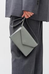 Profile view of model wearing the Oroton Mia Texture Clutch in Grey Flannel and Textured leather for Women