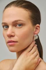 Profile view of model wearing the Oroton Tulip Earrings in Silver and Brass for Women