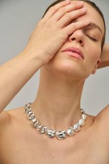 Profile view of model wearing the Oroton Tulip Necklace in Silver and Brass for Women