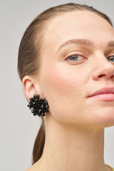 Profile view of model wearing the Oroton Floret Earrings in Black and Brass for Women
