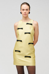 Profile view of model wearing the Oroton Bow Detail Shift Dress in Lemon Zest and 85% polyester, 15% silk for Women