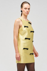 Profile view of model wearing the Oroton Bow Detail Shift Dress in Lemon Zest and 85% polyester, 15% silk for Women