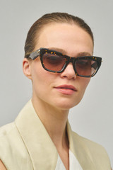 Profile view of model wearing the Oroton Sebes Sunglasses in Neo Tort and Bio acetate (Biodegradeable) for Women