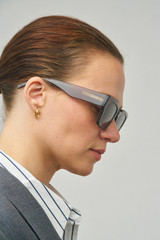 Profile view of model wearing the Oroton Stevie Sunglasses in Soot and Acetate for Women