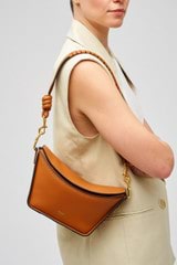 Profile view of model wearing the Oroton Florence Bag Strap in Cognac and Smooth leather for Women