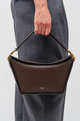 Profile view of model wearing the Oroton Fable Day Bag in Mahogany and Smooth leather for Women