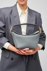 Profile view of model wearing the Oroton Fable Day Bag in Grey Flannel and Smooth leather for Women