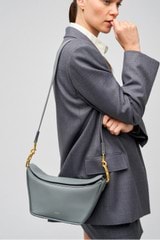 Profile view of model wearing the Oroton Fable Day Bag in Grey Flannel and Smooth leather for Women