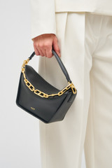 Profile view of model wearing the Oroton Fable Small Day Bag in Black and Smooth leather for Women