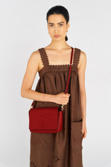 Profile view of model wearing the Oroton Polly Crossbody in Dark Ruby and Pebble leather for Women