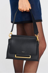 Profile view of model wearing the Oroton Elm Small Satchel Bag in Navy and Smooth Pebble Leather for Women
