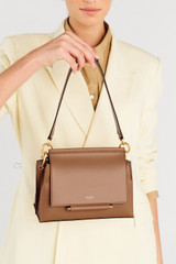 Profile view of model wearing the Oroton Elm Small Satchel Bag in Tan and Smooth Pebble Leather for Women