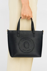 Profile view of model wearing the Oroton Polly Small Tote in Black and Pebble Leather for Women